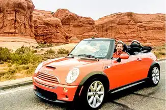 Marc in our 2006 Mini Cooper S Convertible in Hot Orange at Arches NP, Utah.