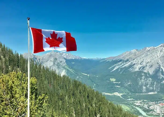 canada flag with scenic canada mountain backdrop
