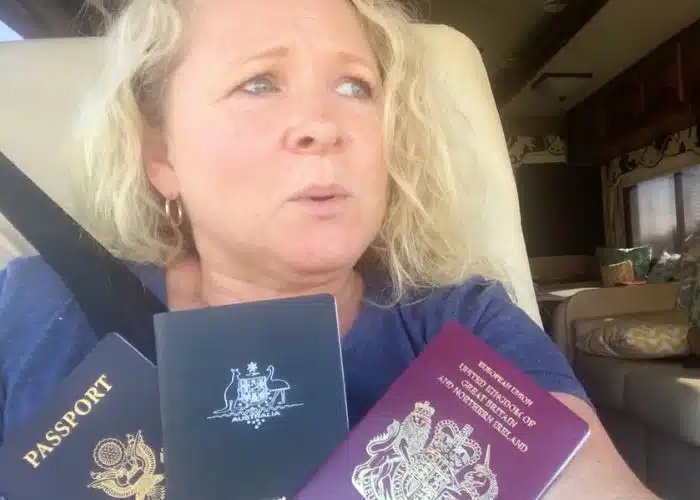 julie holds 3 passports looking worried