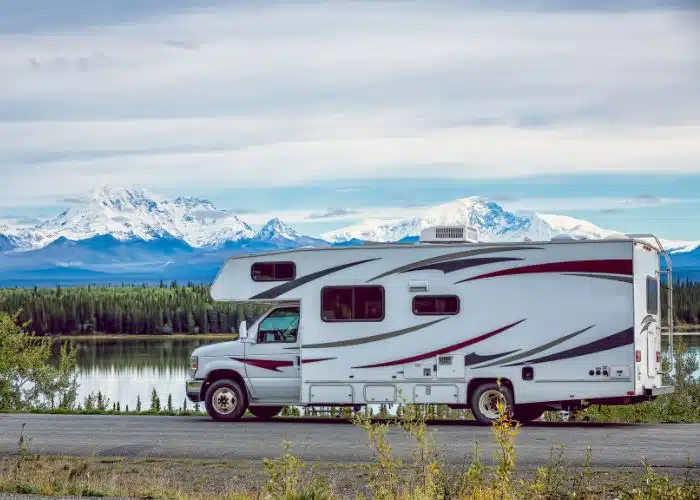 rv parked by side of road and scenic mountain lake view canada