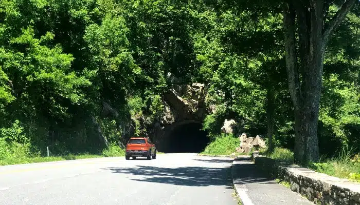 orange jeep driving into marys tunnel on skyline drive in virginia