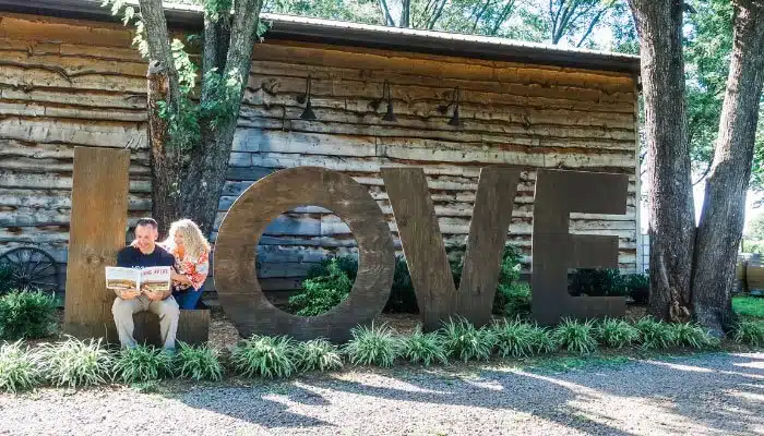 Virginia love works sign made of wood with couple reading a book