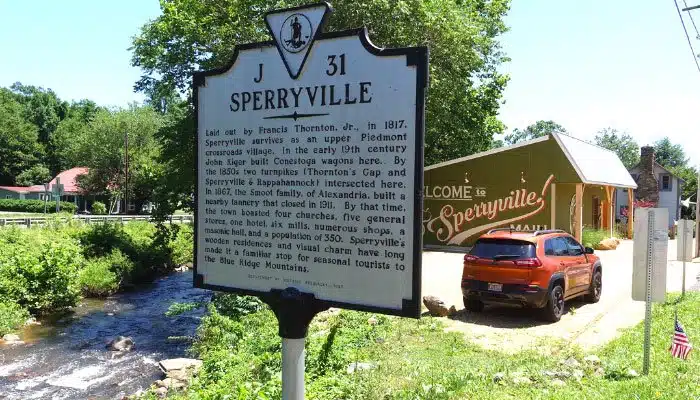 sperryville virginia town sign with jeep and pretty building behind