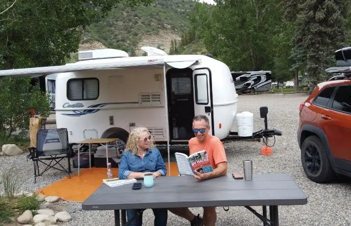 marc and julie of RVLove at campsite reading