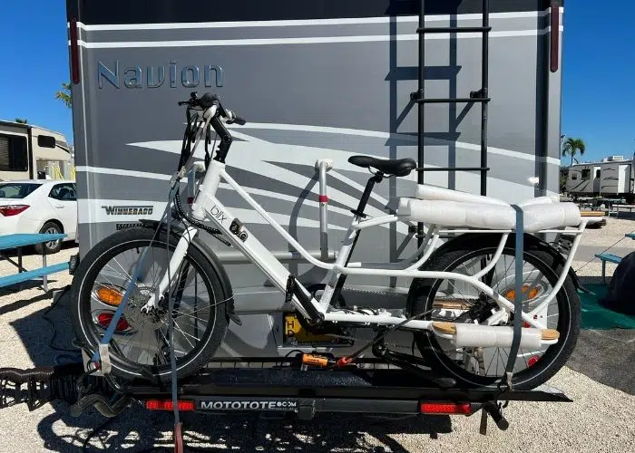 white blix cargo ebike on bike rack of rv