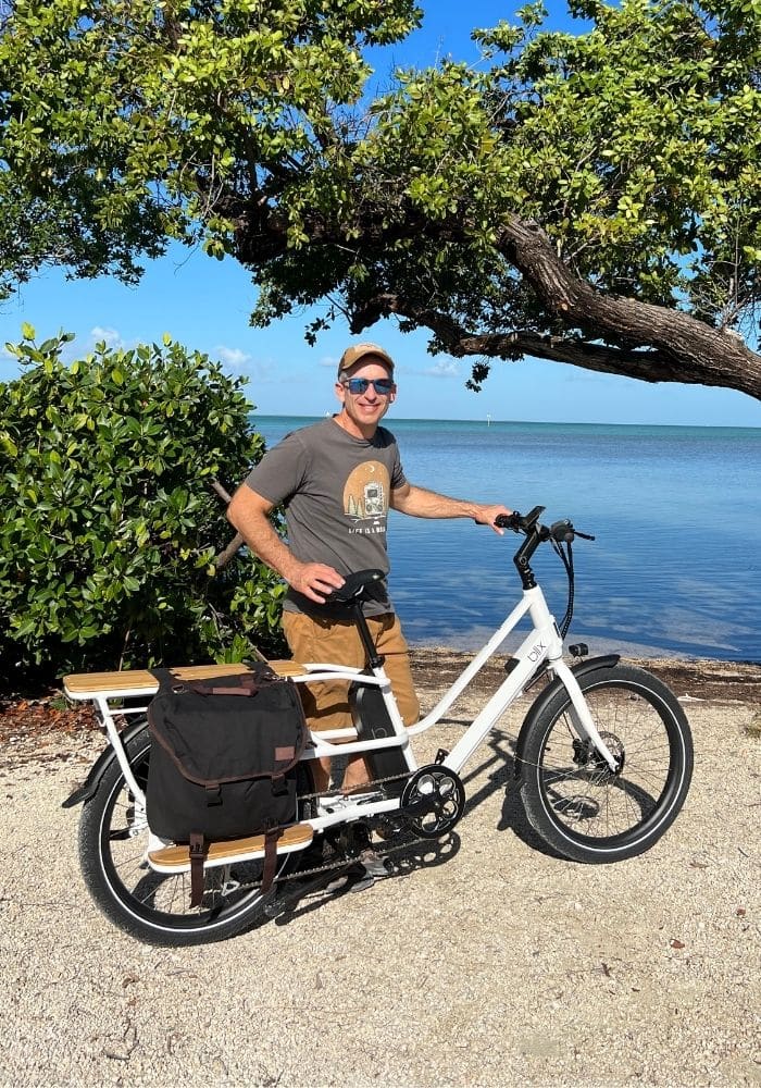 white blix cargo ebike with rider at beach