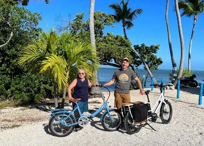 two blix ebikes with riders at beach