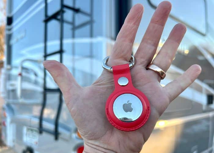 Apple air tag in red keychain with rv in background