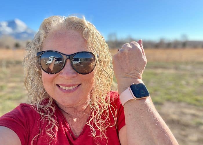 woman with Apple Watch wearing sunglasses