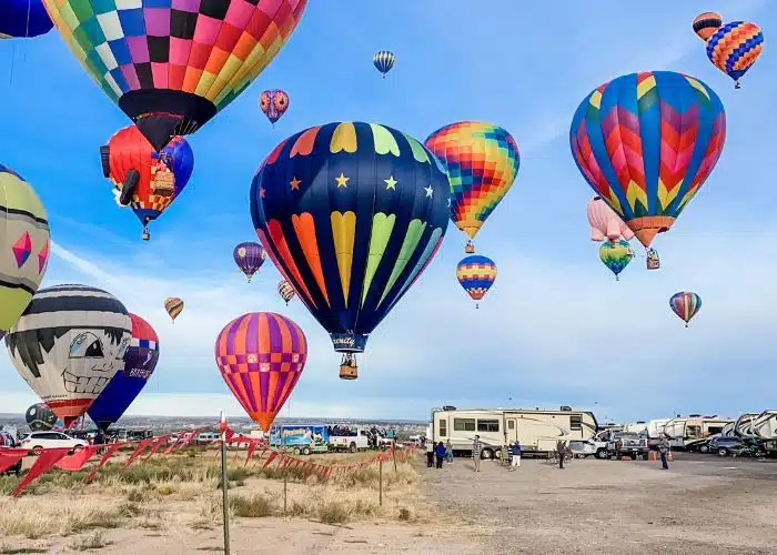 many hot air balloons near ground