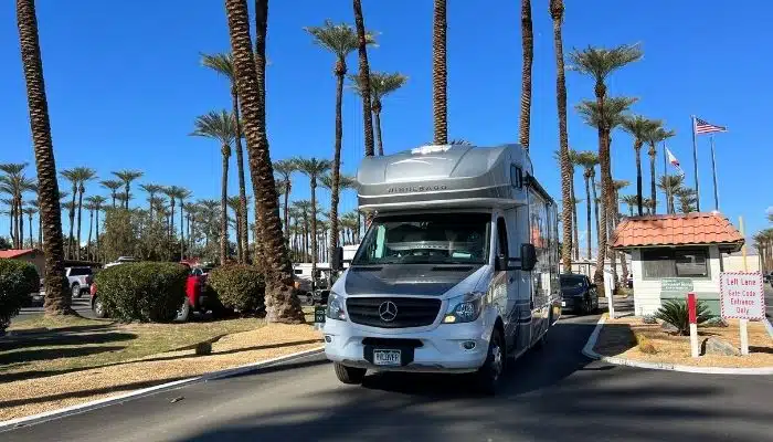 class c rv leaving campground with palm trees