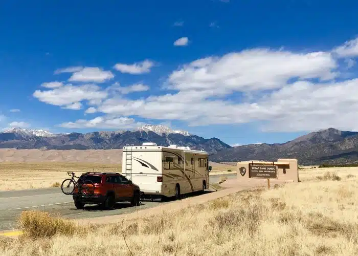 cc motorhome tows jeep at great sand dunes