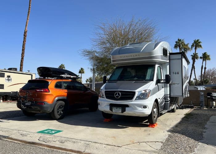 class c rv and jeep in campsite at palm springs oasis