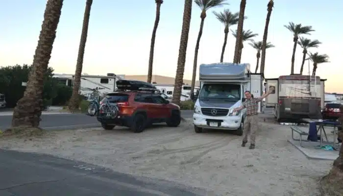 man with rv and jeep in rv site