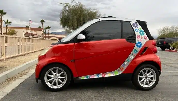 red smart car with floral print stripe
