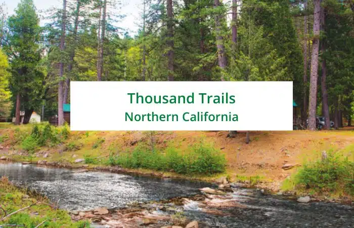 thousand trails northern califonia text with wooded river background