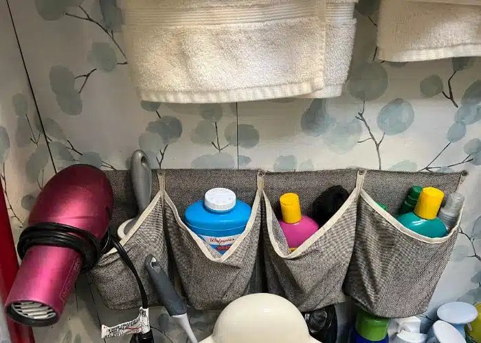 RV bathroom storage caddy holding bottles and hairdryer