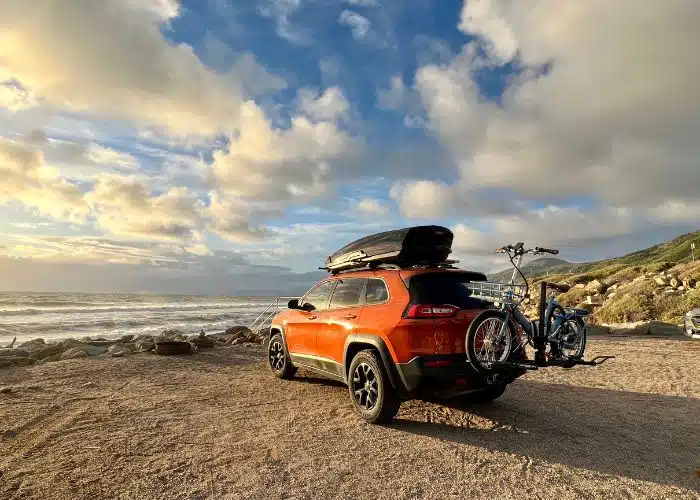 beachfront sunset light on orange jeep