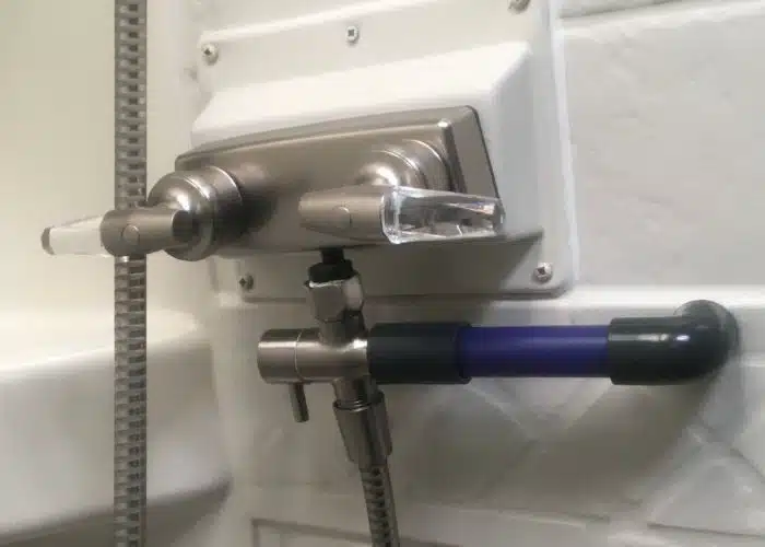 close up of rv shower faucet and shower miser