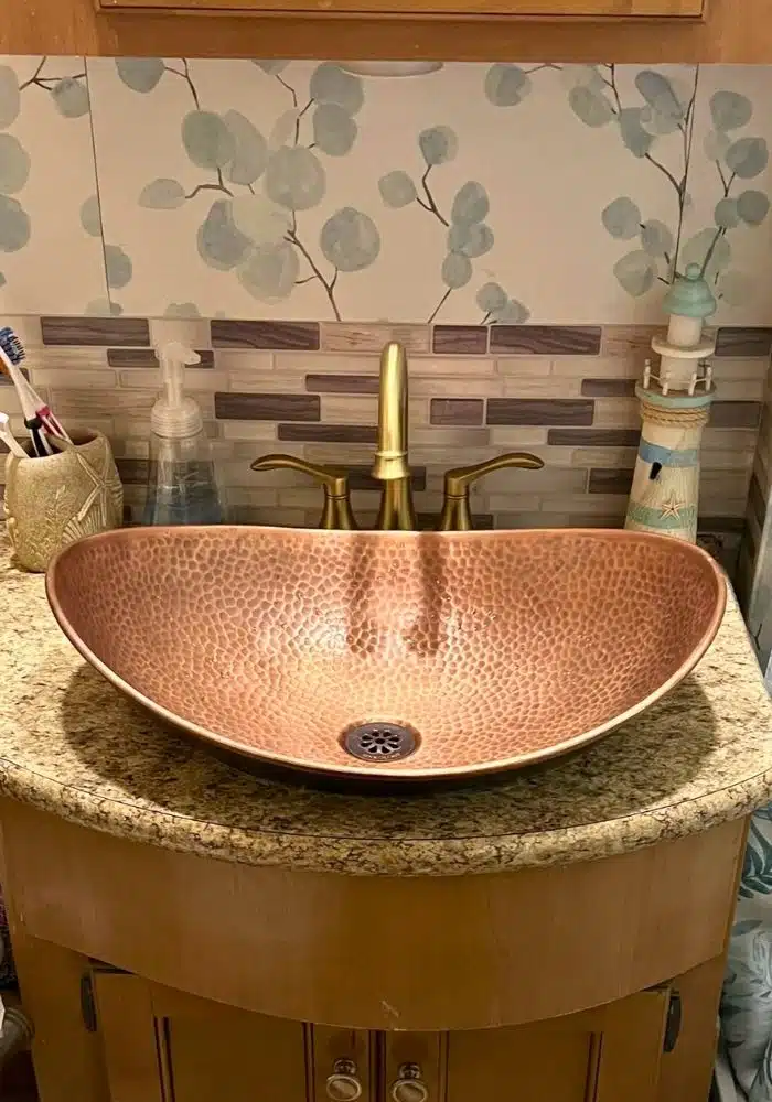 hammered copper vessel sink in rv bathroom