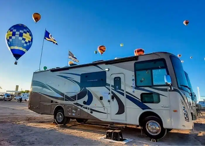 Photo Credit_ Dino Carroll Class A motorhome surrounded by hot air balloons and blue sky