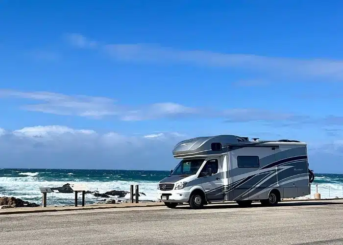 class c motorhome parked by crashing ocean waves Pebble beach Monterey CA