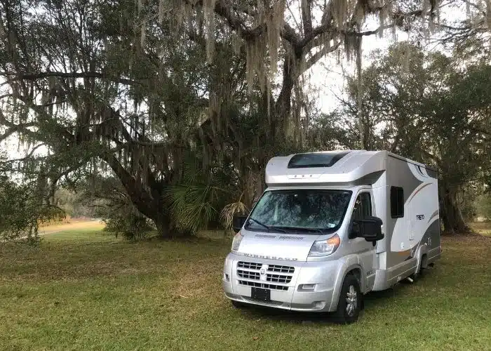 mini motorhome parked on. green grass