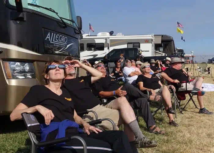 rvs and people wearing eclipse glasses looking at the solar eclipse