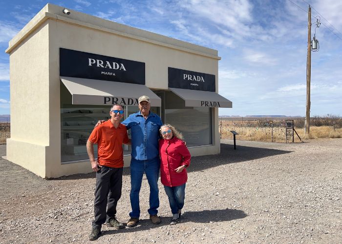 standingn with man who cleans Prada marfa art installation