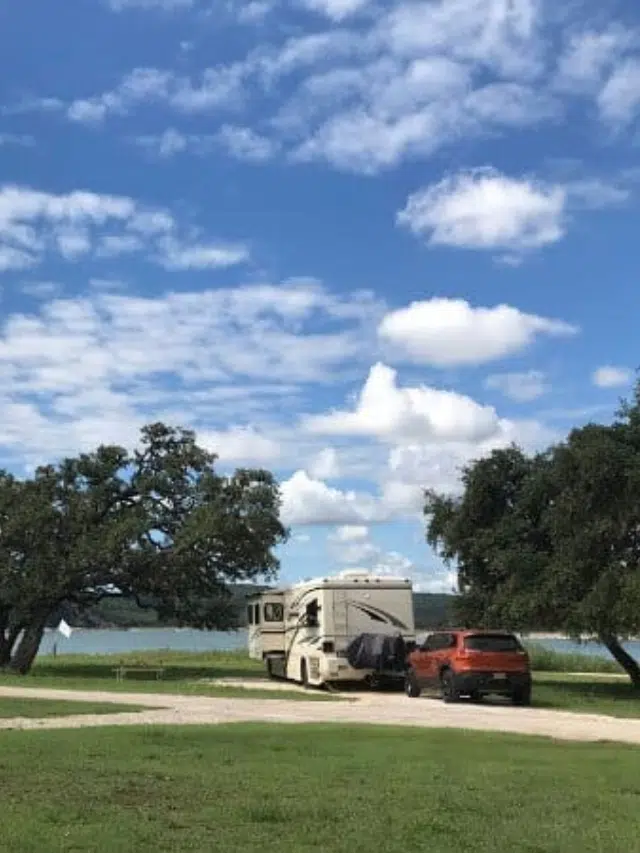 country coach with Jeep at lake in texas