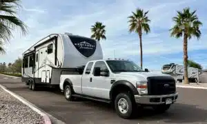 white truck and fifth wheel rv park palm trees