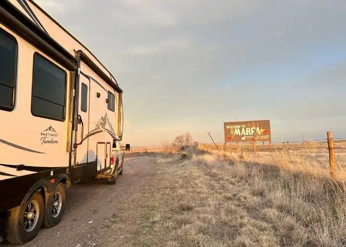 rv parked on side of road by welcome to marfa tx sign