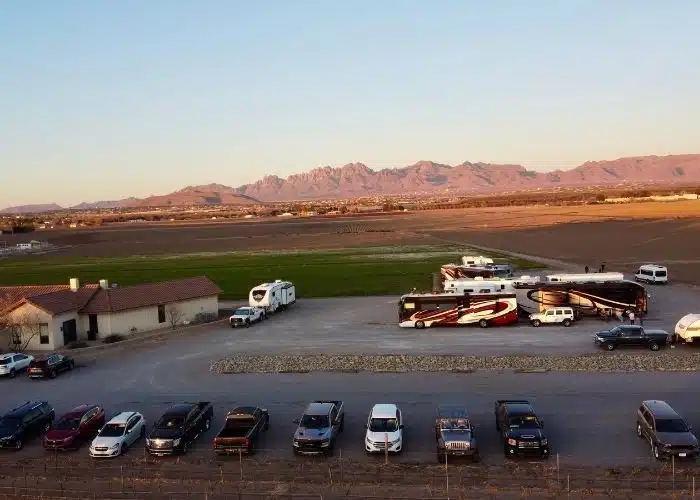 rvs parked in parking lot by winery in las cruces with organ mountains behind at dusk